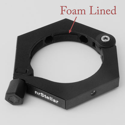 an nrStellar Camera Ring laying down against a white background. It is black, with white text reading "nrStellar". Text reads "Foam Lined", with an arrow pointing to foam on the inside diameter of the ring. 
