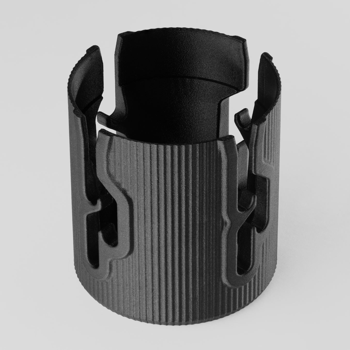 nrStellar Astrocam Port Protector placed upright on a light grey background. It is black, cylindrical, and features slots to manage cables through.