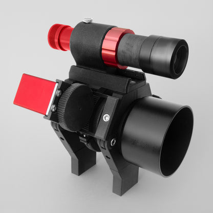 A nrStellar customized ring kit holding a lens. There is a finderscope shoe and a ZWO electronic autofocuser attachment.