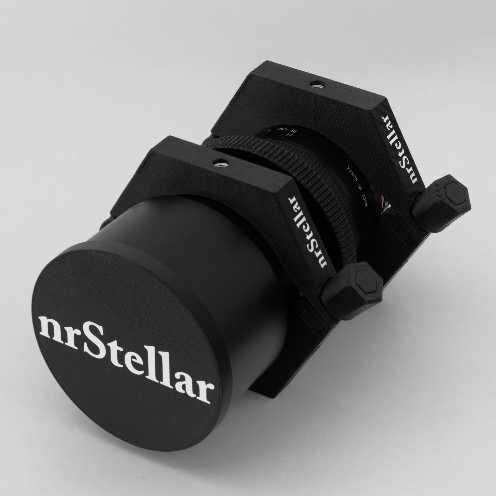 Rokinon/Samyang 135mm f2 lens installed in nrStellar rings with a branded lens cap placed over the lens hood.