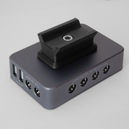 The nrStellar dovetail mount for the SVBONY SV241 Powerbox. It is shown here attached to the powerbox, oriented parallel with the length of the box. 