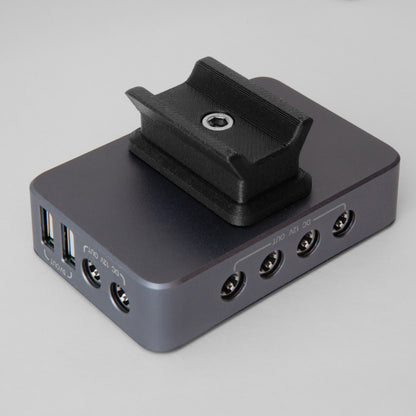 The nrStellar dovetail mount for the SVBONY SV241 Powerbox. It is shown here attached to the powerbox, oriented perpendicular with the length of the box. 