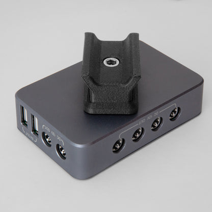 The nrStellar dovetail mount for the SVBONY SV241 Powerbox. It is shown here attached to the powerbox, oriented at an angle relative to the length of the box. 