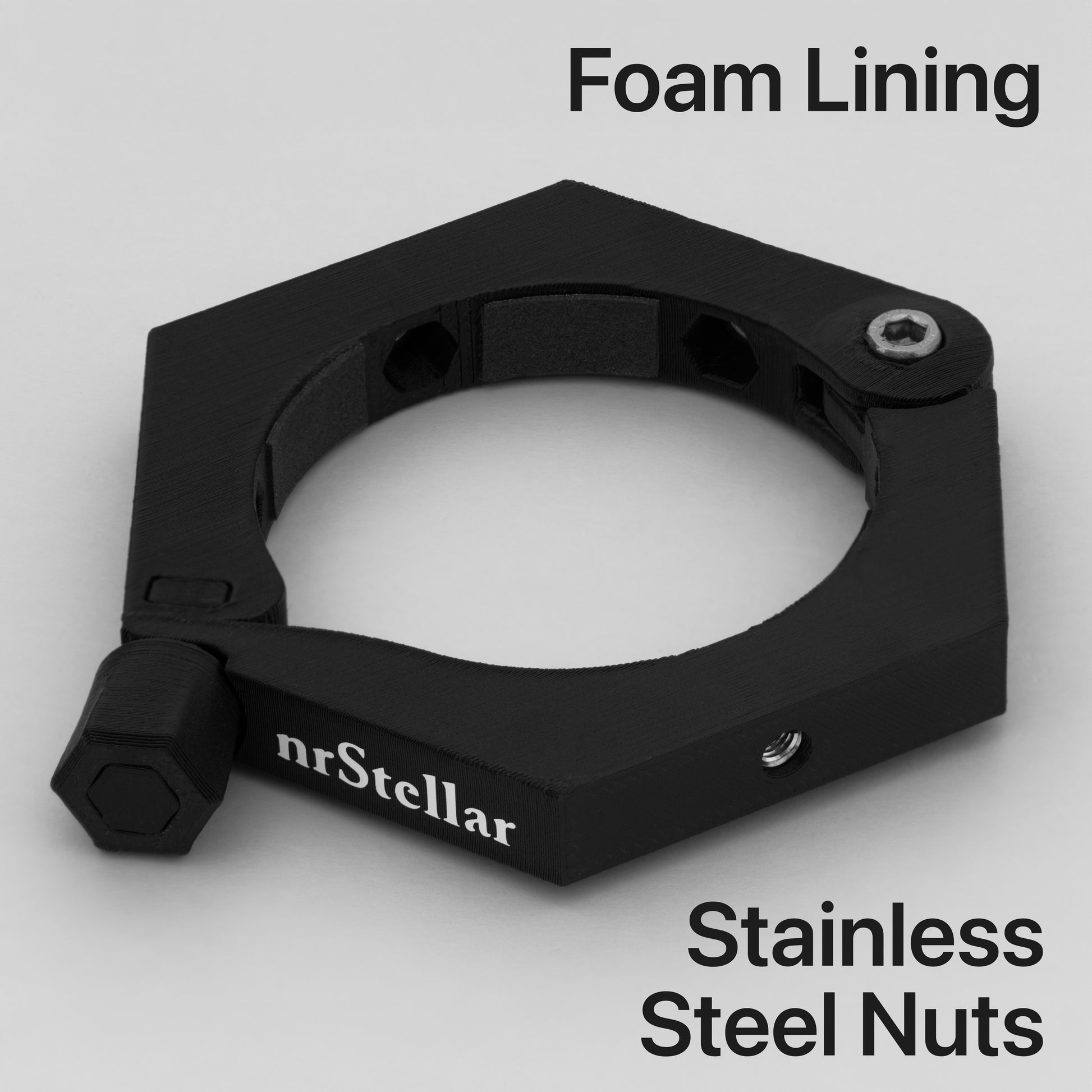An nrStellar camera ring laying down against a light grey background. It is black, with white text for the brand name. Text on the image says "Foam Lining" and "Stainless Steel Nuts"